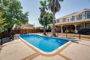 a swimming pool in front of a house at Luxe San Antonio Vacation Rental with Private Pool! in San Antonio