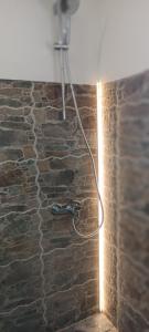 a lamp on a stone wall with a light on it at Vila Jasmina in Kolašin +68 photos