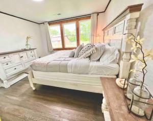 a bedroom with a large bed and a window at small rental for couple getaway in Dalton