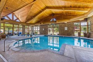 a large indoor swimming pool with a wooden ceiling at The Evergreen Hotel in McCall