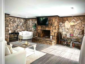 a living room with a stone wall with a tv at small rental for couple getaway in Dalton