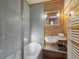 a bathroom with a white tub and a sink at Chalet de charme à Saint Marcel, 4 chambres, 10 pers, proche navette ski, label 5 flocons Or - FR-1-570-18 in Saint-Marcel +5 photos