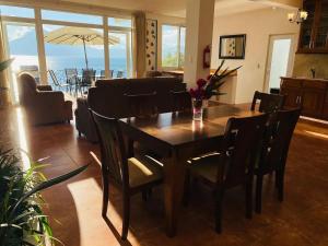 a dining room with a table and chairs with a view at Villa Palopo in Santa Catarina Palopó