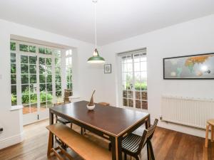 a dining room with a table and chairs at Tor Cottage in Great Malvern