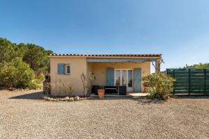 una pequeña casa con una valla delante de ella en Villa Syrah avec piscine privée chauffée à 25 km de la mer, en Coustouge