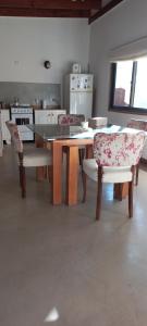 a kitchen with a table and chairs in a room at Suite de campo in Chascomús