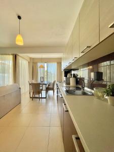 a kitchen with a counter and a dining room at Koumaros Villas in Agia Paraskevi