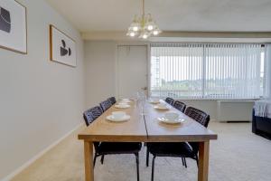 a dining room table with chairs and a large window at Awesome 2 BR Condo @Crystal City With Gym in Arlington