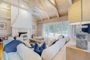 a living room with a large couch and a fireplace at Tranquil Haven in West Tisbury