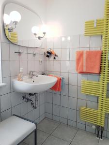 a bathroom with a sink and a mirror at Bungalow in Stralsund