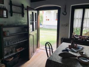a kitchen with a table and a door to a yard at Agriturismo Villa Carlotta in Szilvásvárad +45 photos