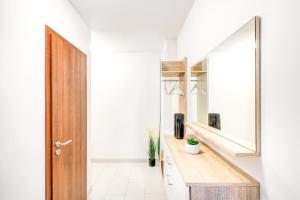a bathroom with a wooden counter and a mirror at Modern apartment with free garage and balcony in the downtown in Budapest