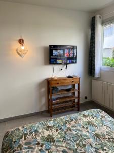 a bedroom with a bed and a tv on the wall at Studio marina baie des anges in Villeneuve-Loubet