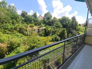 a balcony with a view of a hill with trees at Tiffany by PortofinoVacanze in Rapallo