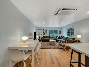 a living room with a couch and a table at Rustic Meadows in Boyne Falls