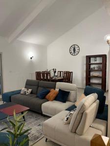 a living room with a couch and a table at La Villa Manee in La Saline les Bains