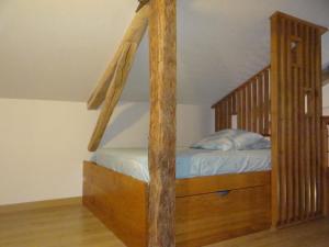 a bedroom with a wooden bunk bed with a staircase at L'Oratori : chambre La Gabarre in Sérignac