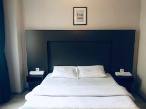 uma cama grande com uma cabeceira preta e duas mesas de cabeceira em OTTO LOFT Premium Apartments em Ancara
