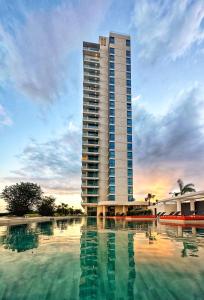 a tall building with a large pool in front of it at Mullet Bay Suites - Your Luxury Stay Awaits in Cupecoy