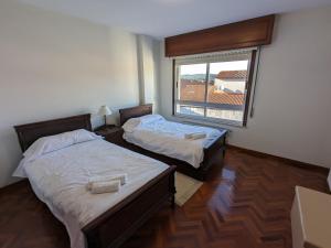 מיטה או מיטות בחדר ב-Apartamento Anduriña