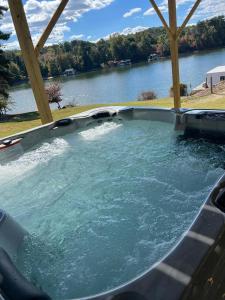 a hot tub with water in it next to a river at Lakeside Haven in Gainesville