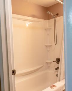 a bathroom with a shower and a bath tub at Oregon Trail Inn in Buhl