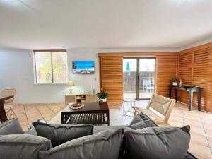 a living room with a couch and a table at Paradise plantation on Noosa Hill 143NI in Noosa Heads