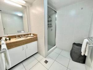 a bathroom with a sink and a shower with a mirror at Paradise plantation on Noosa Hill 143NI in Noosa Heads