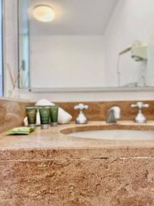 a bathroom counter with a sink and a mirror at Paradise plantation on Noosa Hill 143NI in Noosa Heads