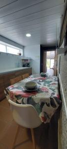 a kitchen with a table with a table cloth on it at Casa Xoubiña in Mos