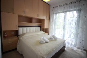 Postel nebo postele na pokoji v ubytování Muko's Apartments