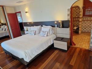 a bedroom with a large bed with two pillows on it at Arena Bianca in Monticello