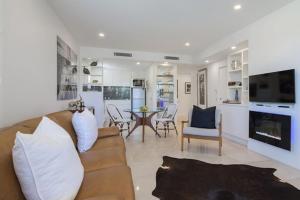 a living room with a couch and a dining room at Luxury in the Heart of Hastings street 628 in Noosa Heads