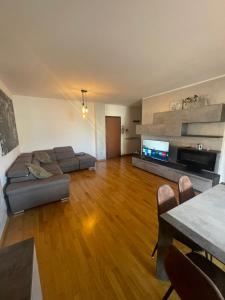 a large living room with a couch and a television at casa vacanza Isa e Rita-con parcheggio privato in Arezzo
