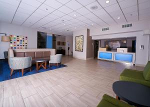 a lobby with a couch and chairs and a table at Holiday Inn Express Charleston-Civic Center, an IHG Hotel in Charleston