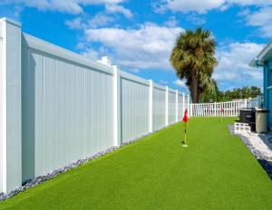 a white fence with a yard with green grass at Ultimate Waterfront Oasis Heated Pool & Boat Dock in Tampa