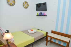 a small bedroom with a bed and a chair at nikola's house in Adamantas