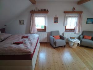 Schlafzimmer mit einem Bett, einem Stuhl und Fenstern in der Unterkunft Relax in Zlatá Koruna