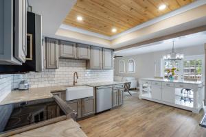 a kitchen with white appliances and a wooden ceiling at Ultimate Waterfront Oasis Heated Pool & Boat Dock in Tampa