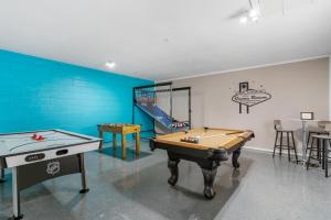 a play room with a pool table and a slide at Ultimate Waterfront Oasis Heated Pool & Boat Dock in Tampa