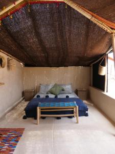 a bedroom with a bed in a room at Berber Beldi Camp in Imsouane
