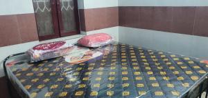 a bed in a room with plastic bags on it at Hallima Service Apartments Non Ac Homestay low Budget in Pudukkottai