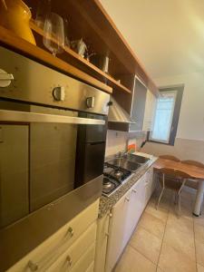 a kitchen with a sink and a stove top oven at casa vacanza Isa e Rita-con parcheggio privato in Arezzo +7 photos
