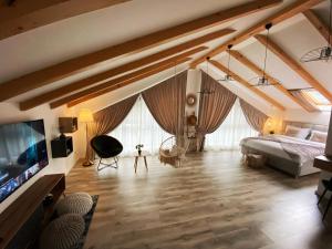 a bedroom with a bed and a tv in a room at QUEEN’S HEART GUESTHOUSE in Bran