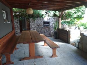 a wooden picnic table sitting on a patio at u koupaliste in Mimoň