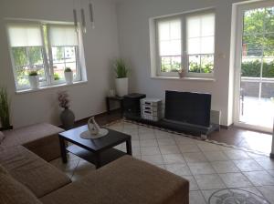 a living room with a couch and a flat screen tv at u koupaliste in Mimoň