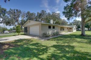 una pequeña casa blanca con garaje en Bright and Spacious Tavares Home with Boat Dock!, en Tavares