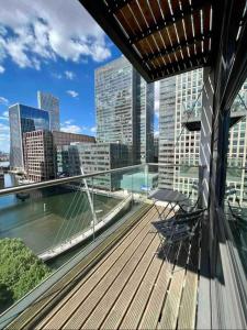 a balcony with two chairs and a view of a city at NEW Two Bedroom Apartment with Balcony in London