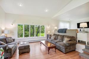 a living room with a couch and a table at Charming and Scenic Gouldsboro Getaway with Patio! in Gouldsboro