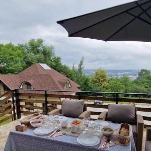a table with plates of food and an umbrella at Provence Suceava in Suceava